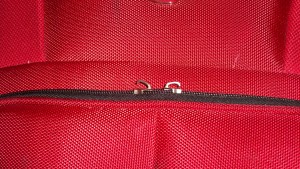 a zipper on a red bag