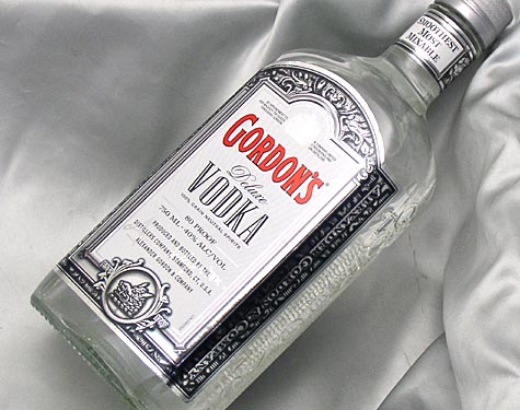 a bottle of vodka on a white satin